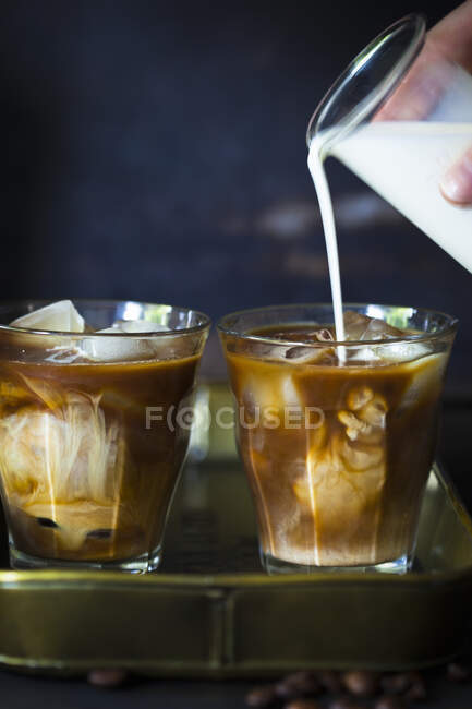 Iced coffee with ice and mint on a wooden table — Stock Photo