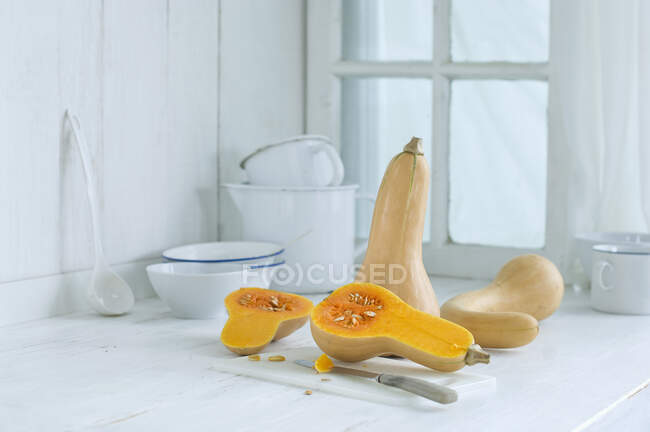 Butternut squash on a rustic kitchen counter — Stock Photo