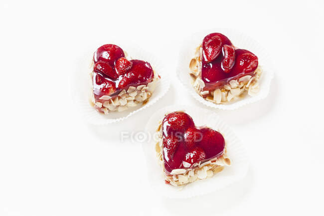 Three heart-shaped strawberry and almond tarts — Stock Photo