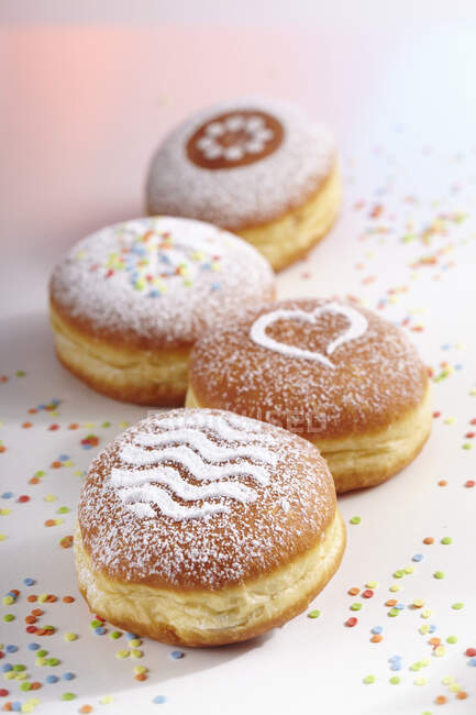 Doughnuts for carnival with various icing sugar patterns — Stock Photo