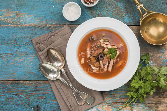 Traditional Russian soup - Solyanka with meat, olives, herbs, lemon — Stock Photo