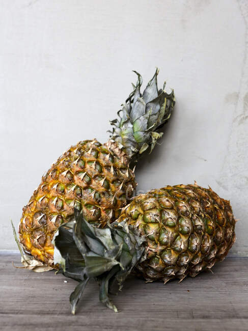 Fresh pineapple on wooden background — Stock Photo