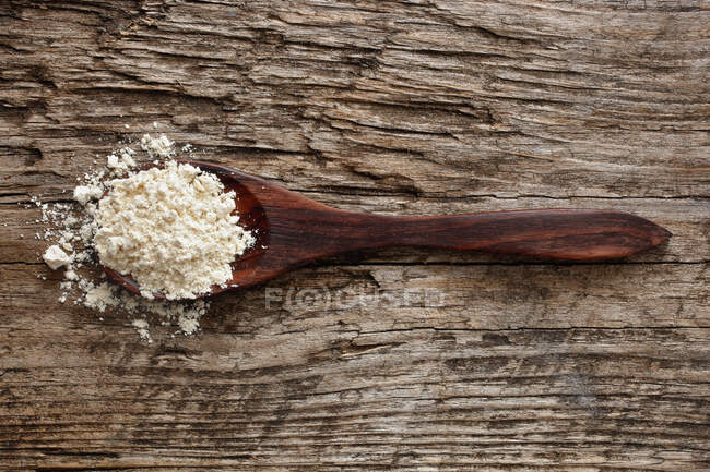 Quinoa flour on a wooden spoon — Stock Photo