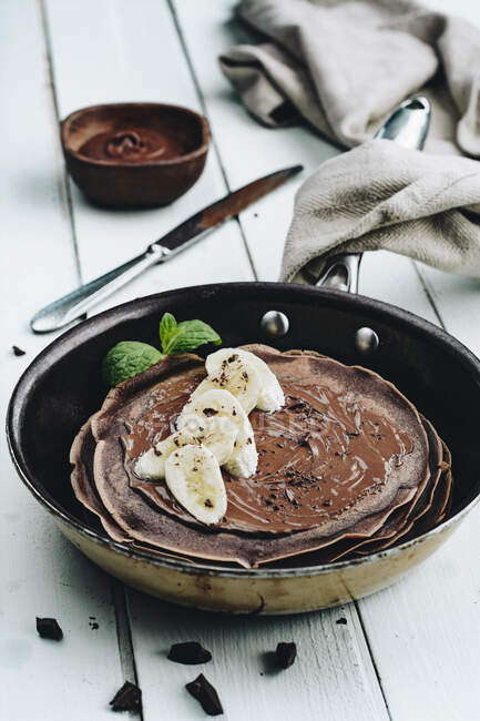 Chocolate pancakes with banana and chocolate icing — Stock Photo