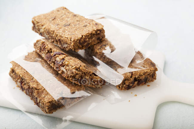 Homemade cereal bars wrapped in paper — Stock Photo
