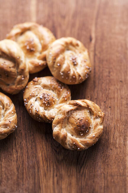 Rose rolls on a wooden surface — Stock Photo