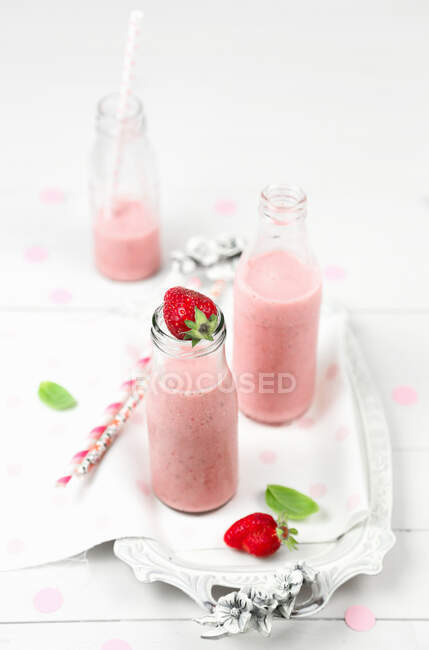 Strawberry smoothie in glass bottles — Stock Photo