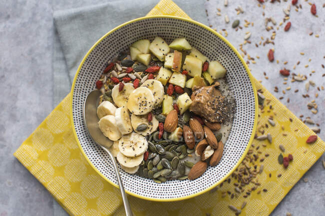 Breakfast bowl of porridge with lots of toppings — Stock Photo