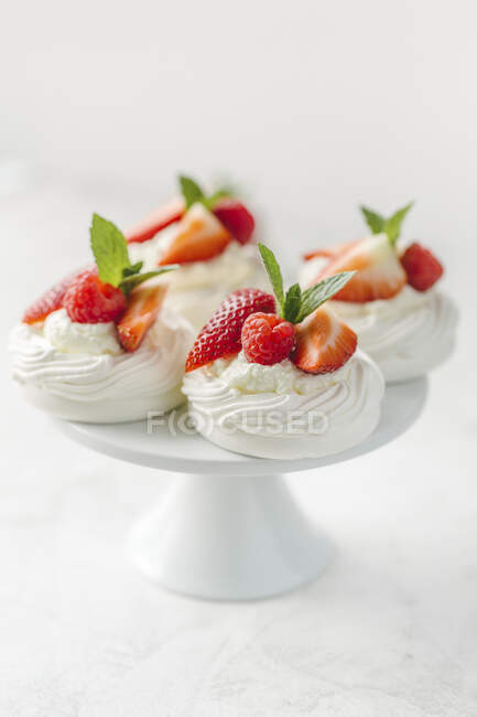Mini pavlovas with whipped cream and berries — Stock Photo