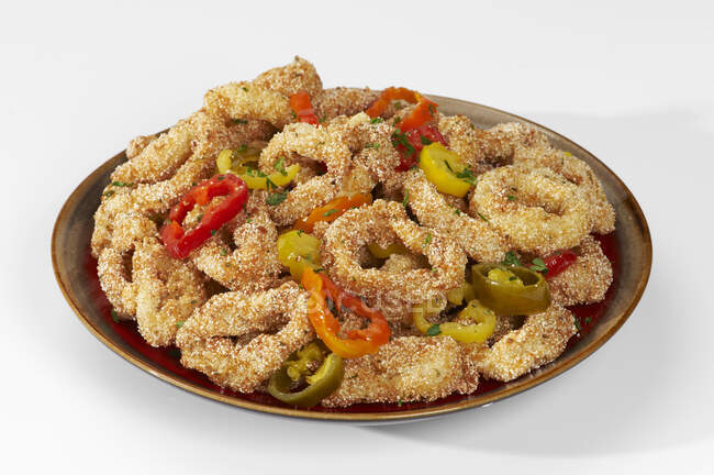 Breaded squid rings with peppers — Stock Photo