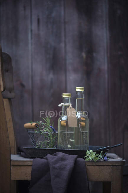 Homemade herbes de provence wine in small bottles — Stock Photo
