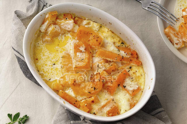 Baked pumpkin in a creamy cheese sauce — Stock Photo