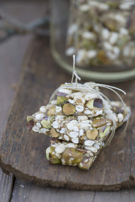 A granola bar with pistachios, sunflower seeds and sesame seeds — Stock Photo