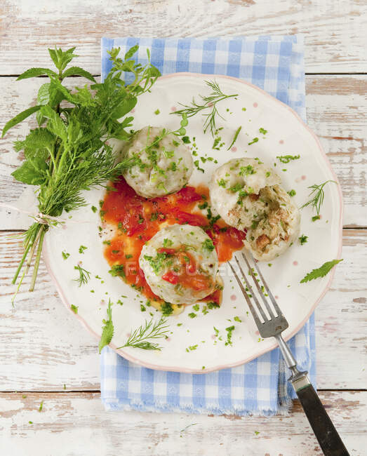 Yeast dumplings with tomato sacue with herbs — Stock Photo