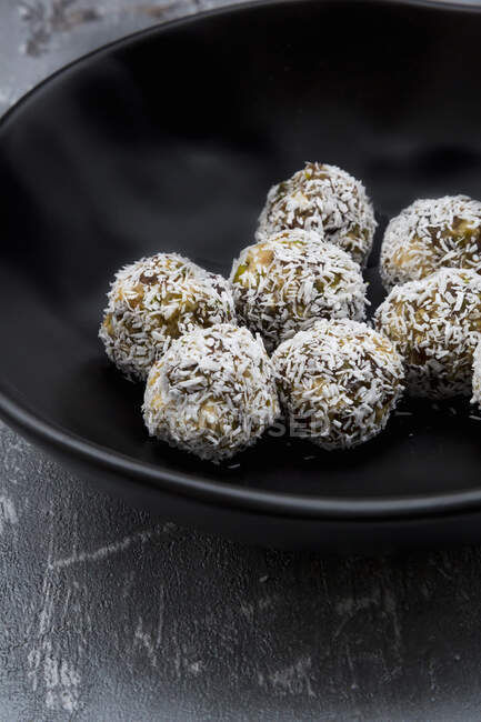 Energy balls made from nuts, fruit and grated coconut — Stock Photo