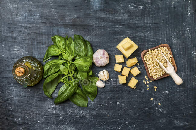 Ingredients for making pesto sauce on a black old background, top view — Stock Photo