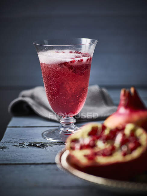 Cocktail made with pomegranate seeds and sparkling wine — Stock Photo