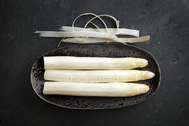 Fresh white asparagus on black background — Stock Photo