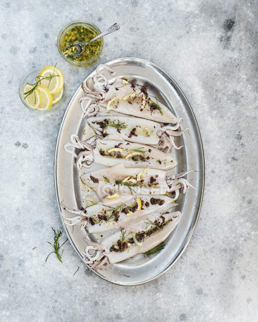 Fresh Adriatic Sea squid with lemons and marinade — Stock Photo