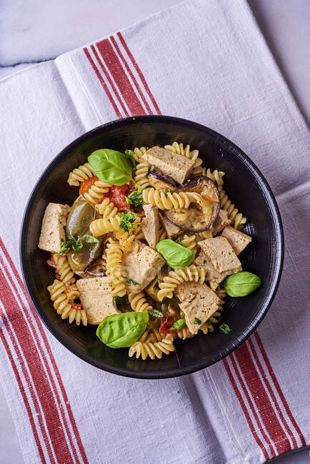 Spiral pasta with tofu, vegetables and basil — Stock Photo