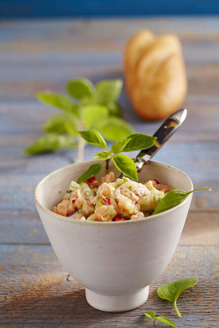Oriental salmon tartare in a ceramic bowl with baguette — Stock Photo