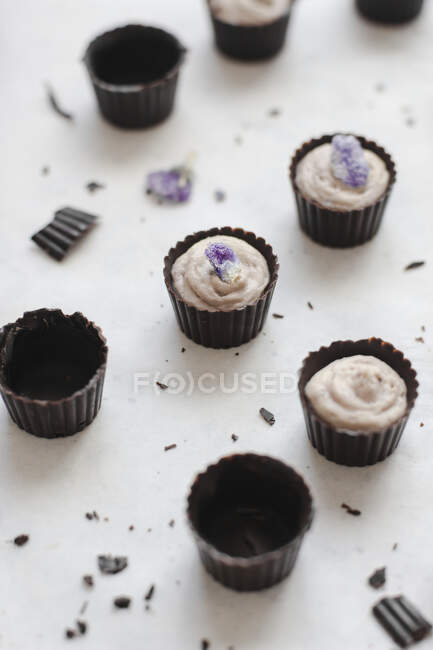 Buttercups de chocolate com violetas cristalizadas — Fotografia de Stock
