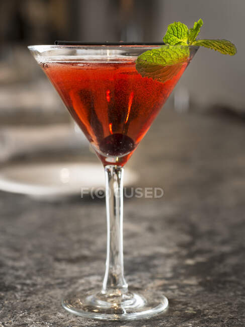 Negroni cocktail with olive and mint leaves — Stock Photo