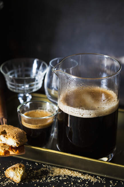 Coffee served in a pitcher, and glasses on a tray with cantuccini — Photo de stock