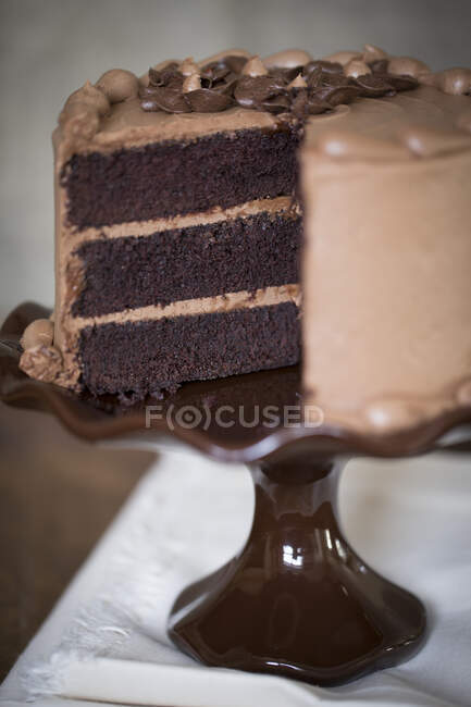 Uma fatia de bolo de creme de mocha em uma banca de bolo, fatiada — Fotografia de Stock