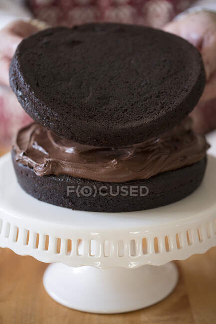 A cake being made: cakes being placed together — Stock Photo