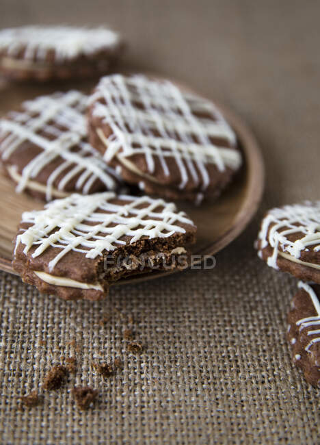 Cream filled chocolate biscuits on sack surface — Stock Photo