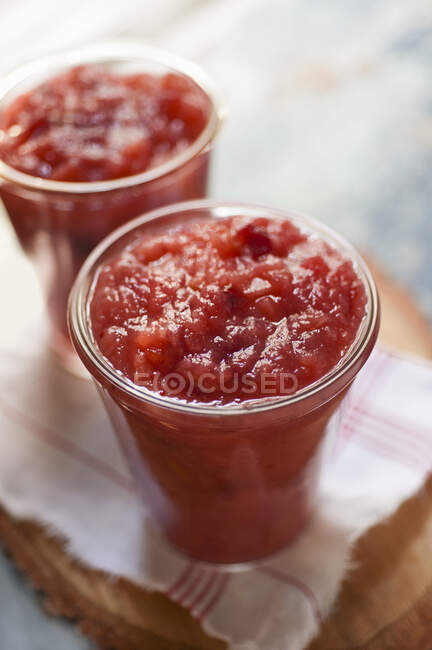 Apple and cranberry sauce in glasses — Stock Photo