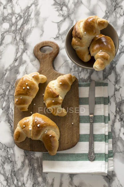 Sweet breakfast croissants made with yeast dough and hail sugar — Stock Photo