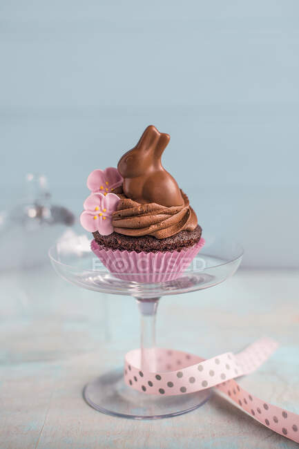 Easter chocolate cupcake on a glass stand — Stock Photo