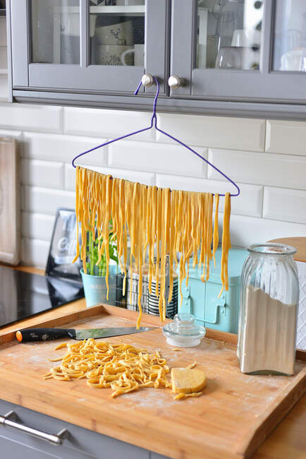 Tagliatelle pasta, drying pasta, drying pasta on a hanger — Stock Photo