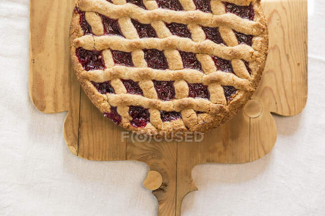 Linzertorte, nut and jam layer cake on a wooden board — Stock Photo