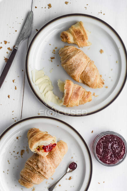 Croissants with butter and strawberry jam — Stock Photo