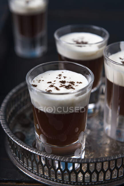 Glasses of coffee schnapps with cream on a tray — Foto stock