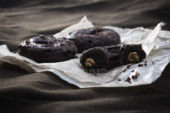Vegan doughnuts with a peanut butter filling and a dark chocolate glaze — Stock Photo