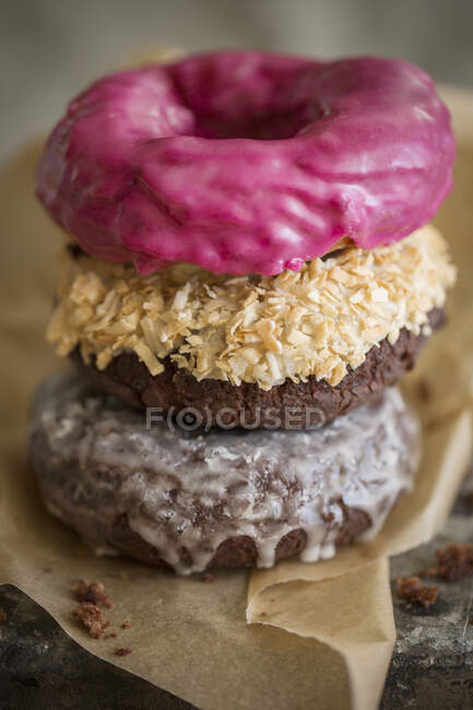 Three donuts with different glazes, stacked — Stock Photo