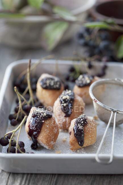 Pastry biscuits with aronia jam and crumbs crushed in a mortar — Foto stock