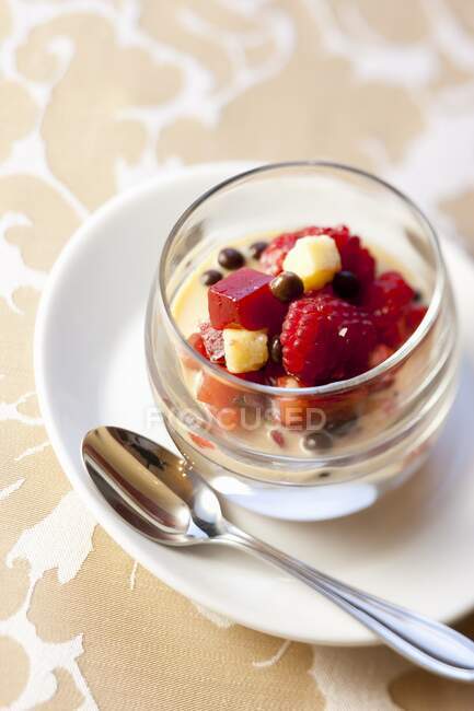 Vanilla cream with fruit salad and chocolate balls — Stock Photo