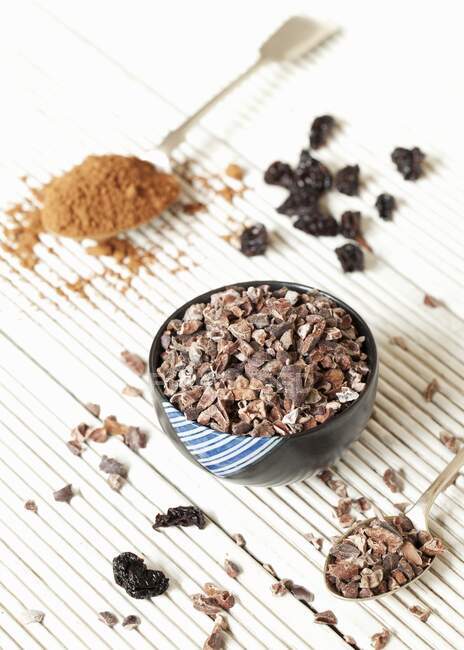 Still life with coconut pieces, dried cherries and cocoa powder — Stock Photo