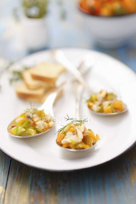 Fish tartare with peppers, fennel and pine nuts — Stock Photo