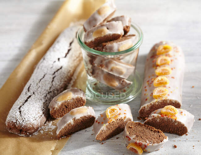 Spiced Christmas bread with icing and candied oranges — Stock Photo
