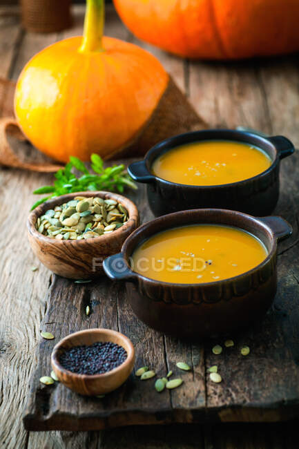 Pumpkin soup on wooden table — Stock Photo