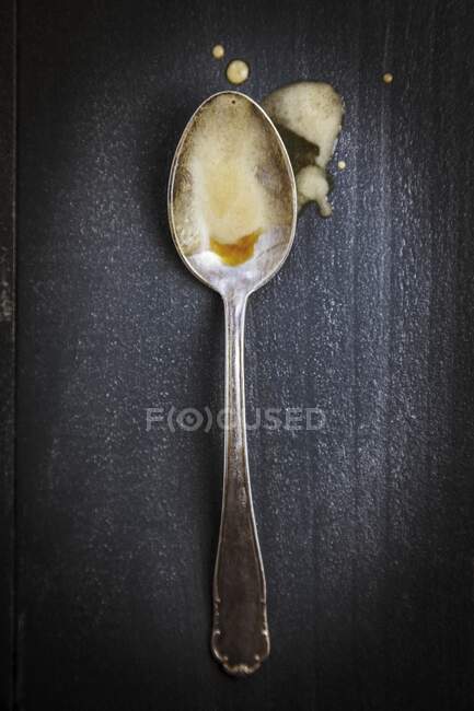 Beer foam on a silver spoon — Stock Photo