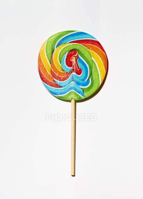 A colourful lolly on a white surface — Stock Photo