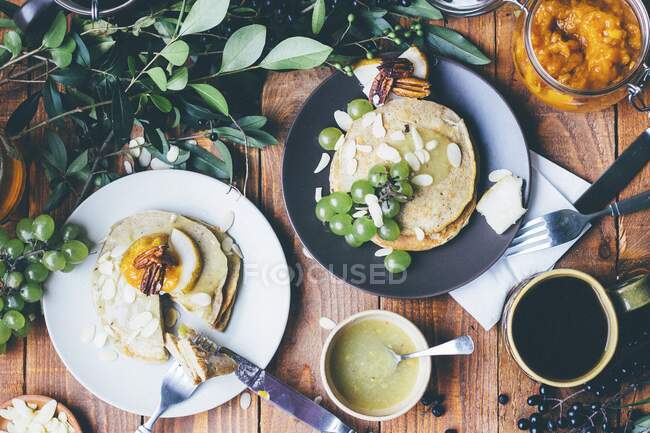 Pancakes with fruit and almond flakes — Stock Photo