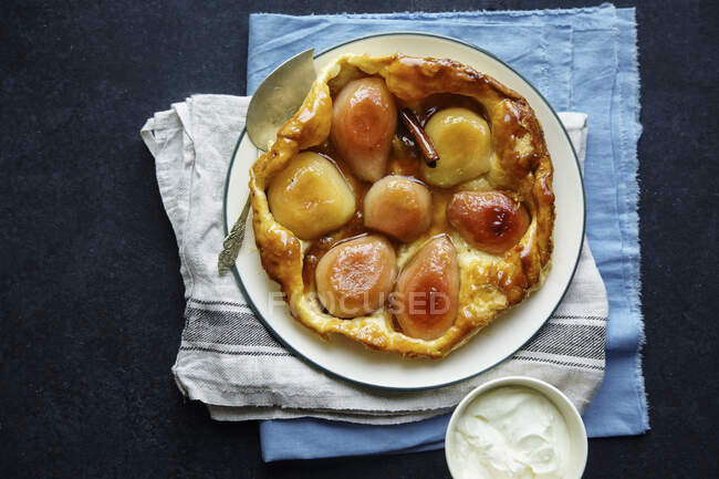 Tarte tatin with pears and whipped cream — Stock Photo